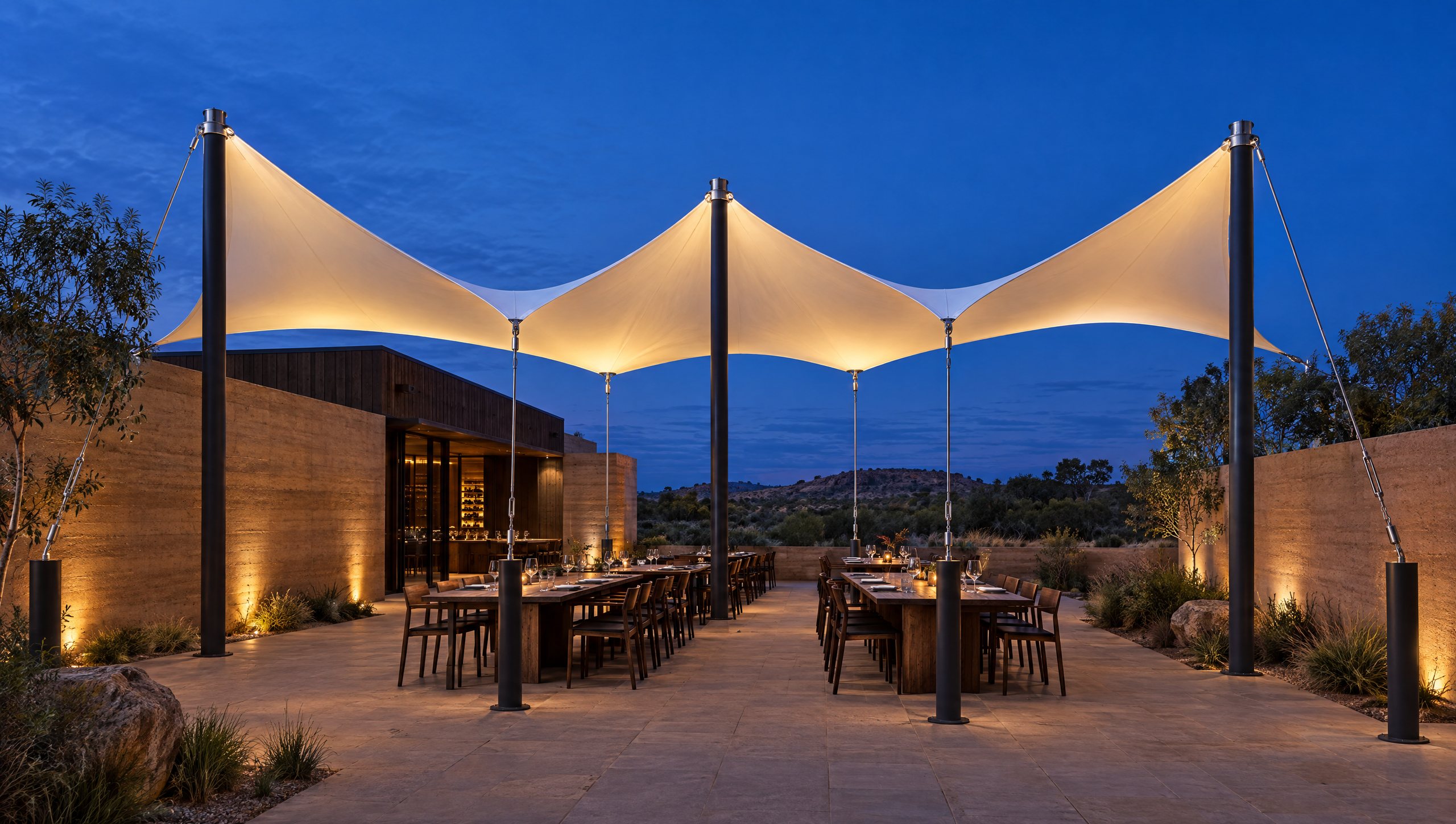 Concept visualisation: an illuminated three-saddle membrane over an outdoor dining courtyard at dusk.
