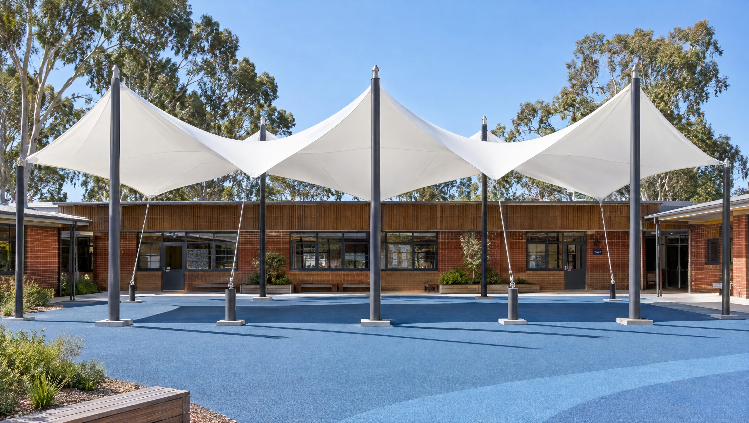 Concept visualisation: a long white membrane roof of alternating high and low points over a school courtyard.